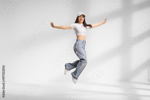 Fotografía Young female jumping in a room