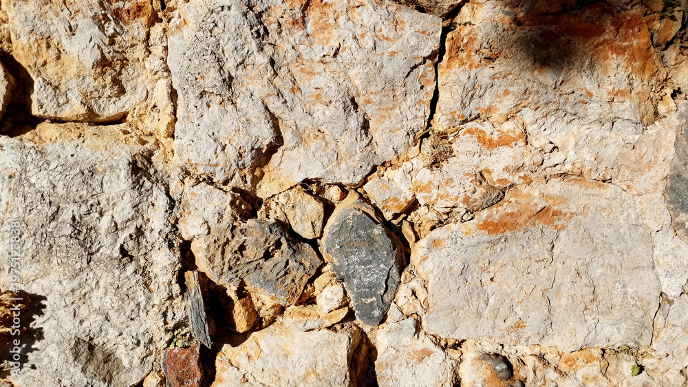 Fototapeta premium photo of a stone wall surface stone masonry with mortar between the stones ancient fortress