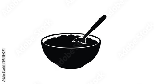 A black bowl filled with something and a spoon resting on the side silhouette