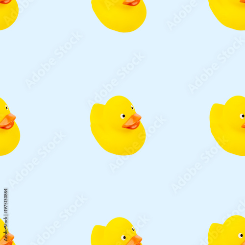 Seamless pattern featuring bright yellow rubber ducks on a blue background. Perfect for children's products, playful designs, and whimsical themes.