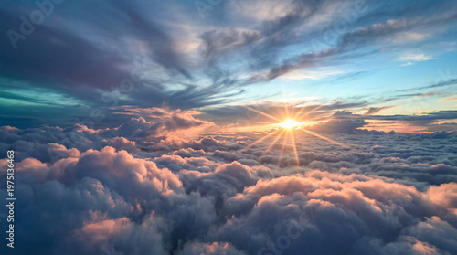 Fotografie A serene aerial view of fluffy white clouds illuminated by a bright sun at sunri