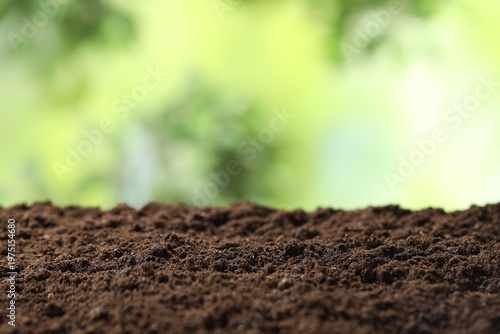 Fresh soil on blurred background, closeup. Space for text