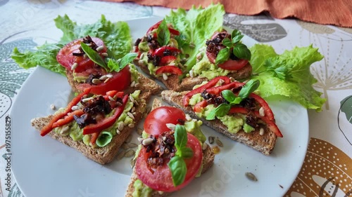 Fresh vegetarian toast slices with guacamole, tomatoes, herbs and salad