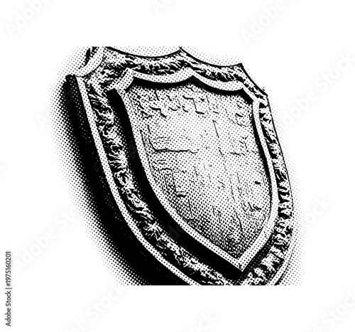 An old shield plaque with heavy engraved detailing and classic ornamental borders, partially cropped at the frame edge for dynamic composition, black and white
