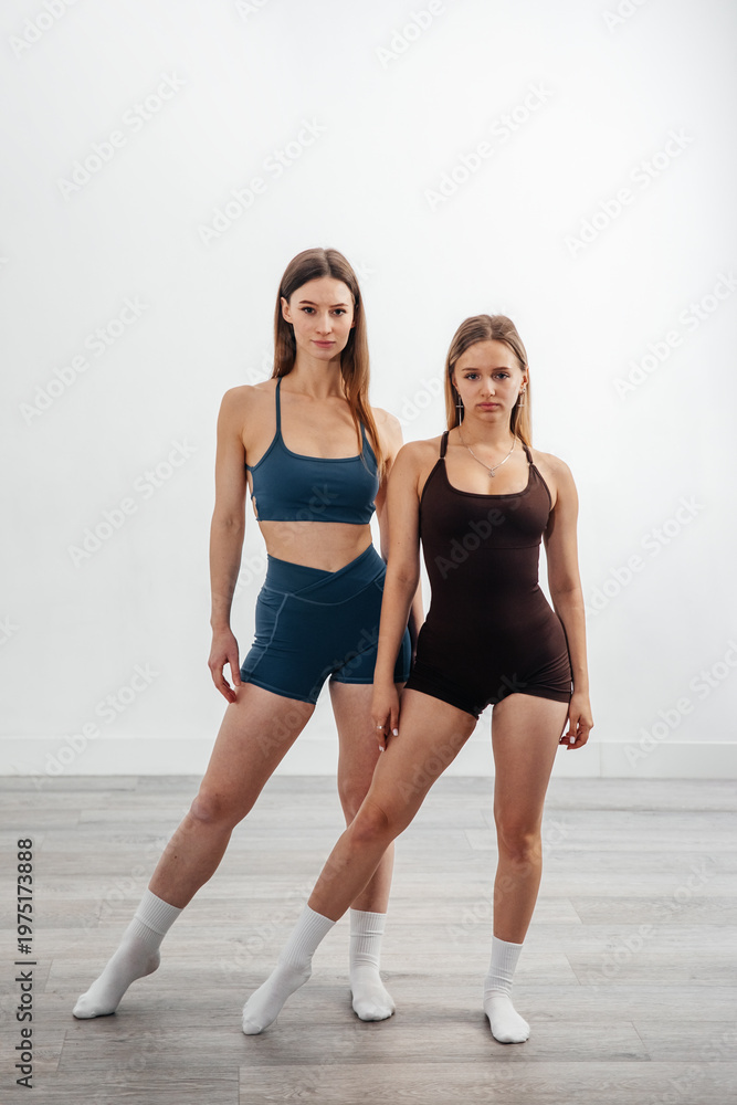 Obraz premium Attractive Women Standing in Sportswear in Gym Studio. Fitness Lifestyle Concept