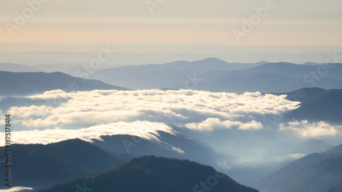 Konstfotografi Temperature inversion view from Ceahlău Massif in Romania showing dense sea of fog filling mountain valleys beneath soft morning light