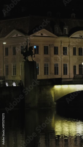 Zurich Bridge Reflection. Nighttime Zurich Scene With Illuminated Bridge And Serene Water Reflection