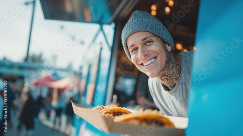 Happy bearded chef serving fresh tacos from a blue food truck