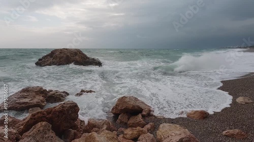 Ocean waves hitting coastal rocks on shoreline

