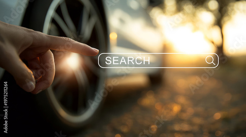 Hand reaching towards search icon in sunlight. Car in background.