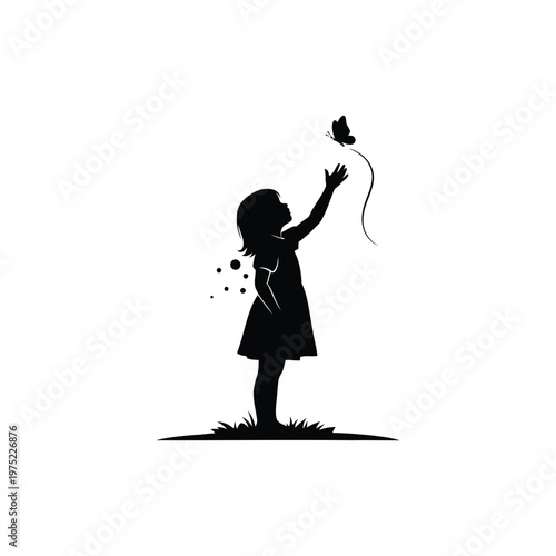 A little girl is releasing a butterfly into the air outside.