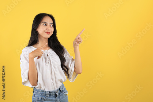 Принти на полотні Asian Teenager with Long Hair and Casual Fashion, Pointing on Top