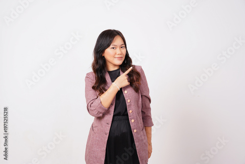 Fotografie Smirking Professional Woman Pointing Finger to Side Direction
