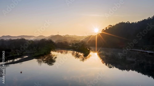 Wallpaper Mural Aerial time-lapse of Sunrise at Moon Bay with Radiant Sunburst and Mirror-Like River Reflections, Wuyuan county, Jiangxi province, China. Torontodigital.ca