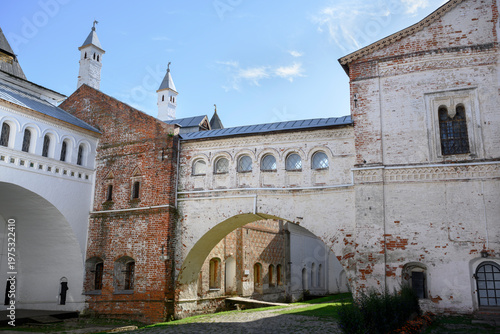 The paved courtyard of a medieval monastery with ancient buildings and arched passages between them in Rostov the Great