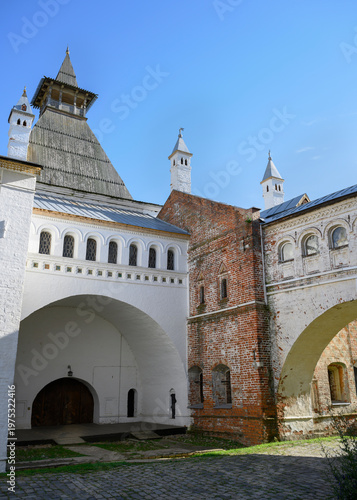 The paved courtyard of a medieval monastery with ancient buildings and arched passages between them in Rostov the Great