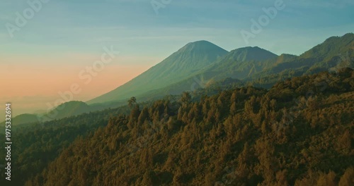 Cinematic aerial of mountain lake with soft natural light and hills