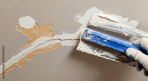 Plastering the Imperfections: A close-up view capturing the art of plastering as a skilled hand meticulously repairs damage on the wall with plaster and tools, bringing walls to life again