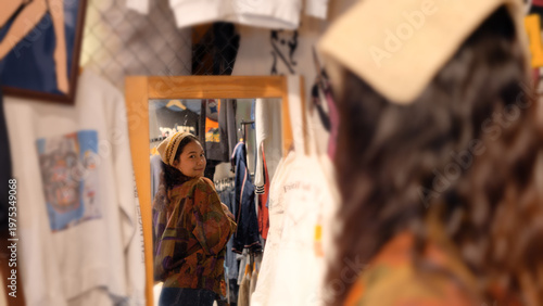 Young tourist Gen Z asia female choose look at zero waste eco go green buy second hand sale store flea market thrift old used vintage street hat style. Happy woman city asian people small retail shop.