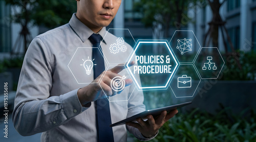 Professional man touching digital screen with policies and procedure icons in a modern business setting at dus