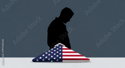 Silhouette of a man kneeling on an american flag draped coffin in dark room