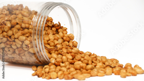 Roasted peanuts isolated on a white background, top view. Pile of shelled peanuts with a few scattered nuts on white background. Dry roasted peanuts isolated on white.
