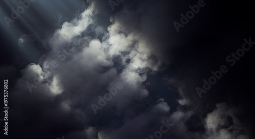 Clouds drift across a dark sky with natural sunlight breaking through.