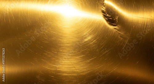 Metal surface reflects bright light with circular brushed texture.
