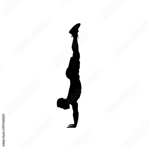 Silhouette of a person doing a handstand outdoors