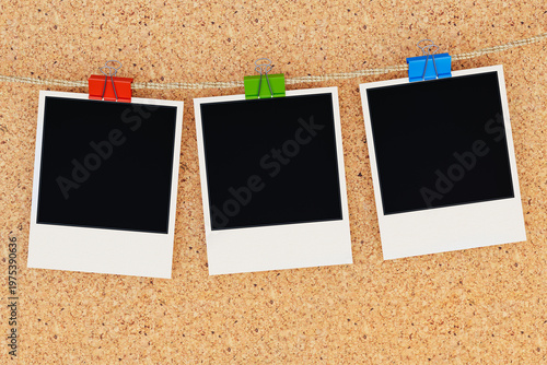 Obraz na plátně Three Blank Instant Photo Frames Hanging on Rope with Colorful Binder Clips on C