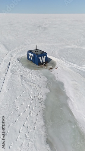 Ice Fishing Hut Frozen In Ice On Lake Manitoba