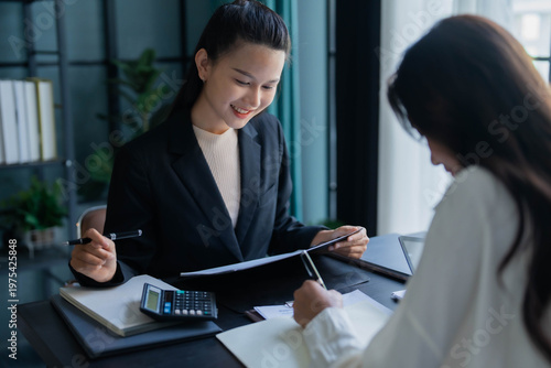 Two Asian businesswoman working together in office room