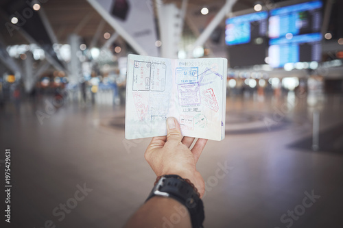 Foto Hand, passport and check for stamps at airport in lobby, arrival and compliance on international trip