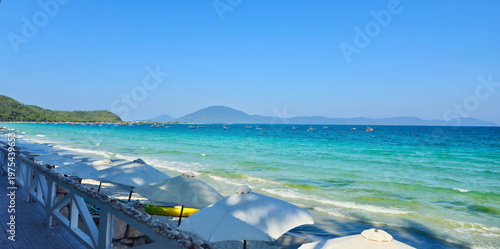 Fotografie Panoramic view of Doc Let beach with white umbrellas, turquoise ocean and fishin
