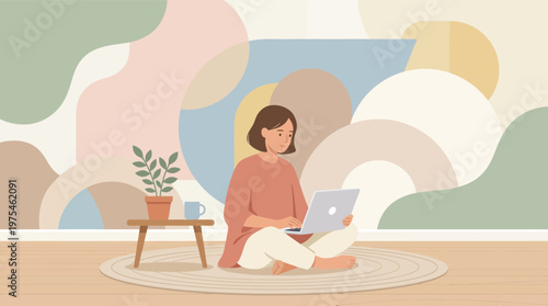 Woman sitting cross-legged on floor using laptop in cozy home office with plant and abstract colorful background
