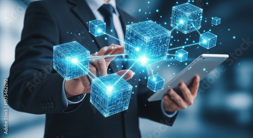 Digital Network Connection: A sharp image that showing businessman wearing formal suit and holding tablet computer while interacting with illuminated digital cubes.