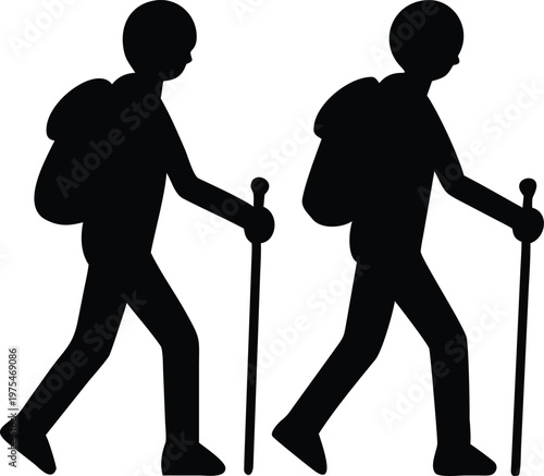 Silhouettes of two hikers walking with trekking poles outdoors