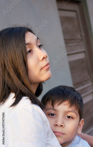 Thoughtful loving little latin siblings.