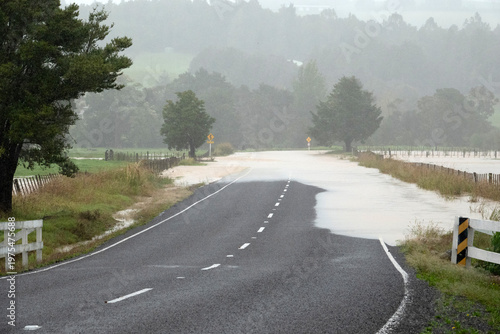 Flooded rural road after heavy rain in Northland New Zealand