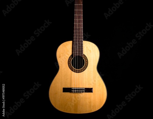 Acoustic guitar, centered on black, showcasing wood grain and detail
