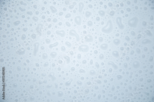 Large water droplets on a white background close-up. The concept of water, rain, humidification. High quality photo