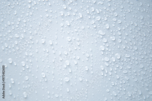 Abstract background, large and small water droplets on white background, close-up. The concept of water, rain, humidification. High quality photo
