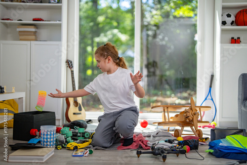 Bild auf Leinwand Child tidying scattered toys on the floor