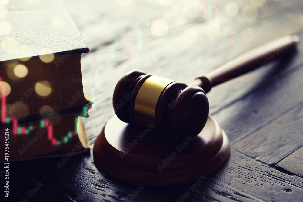 Obraz premium Wooden judge gavel and legal book on wooden table