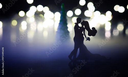 Black silhouettes of pair dancers performing. Man and woman are dancing with white backlight. Choreography. New Year's ball