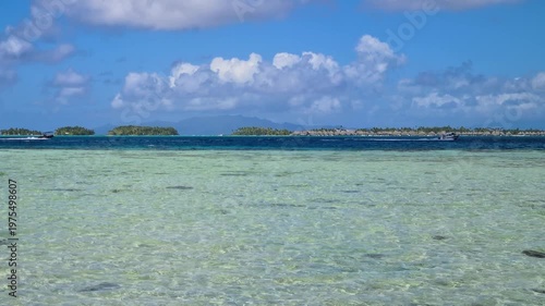 Bora Bora, French Polynesia, Timelapse of Boats in Lagoon and Clouds Above Tropical Resort