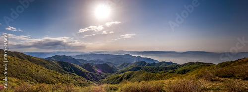 Quadro em tela Sunny day with bright sun over mountainous landscape