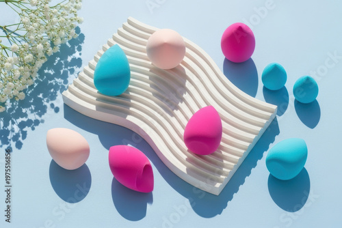Colorful Beauty Blender Makeup Sponges in Pink Teal and Blue on White Wavy Stand with Baby's Breath, Cosmetic Product Photography