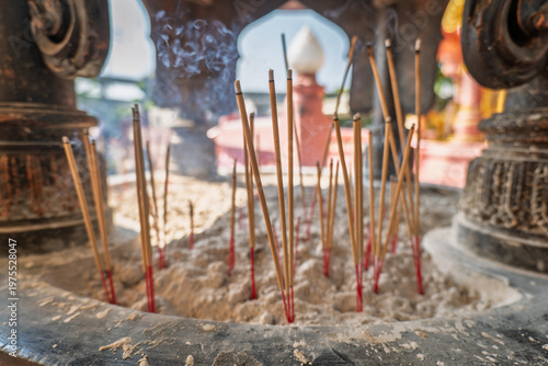Burning incense sticks in a Buddhist Temple in Thailand.