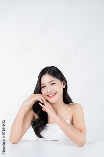 Beautiful portrait of young asian woman with healthy facial and body skin and glowing makeup for advertise skincare product.